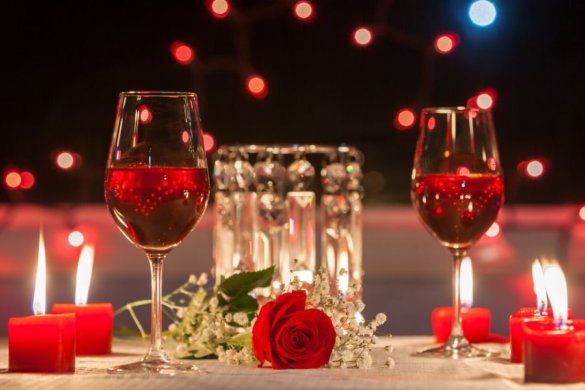 Romantic dining two glasses with red wine and candles