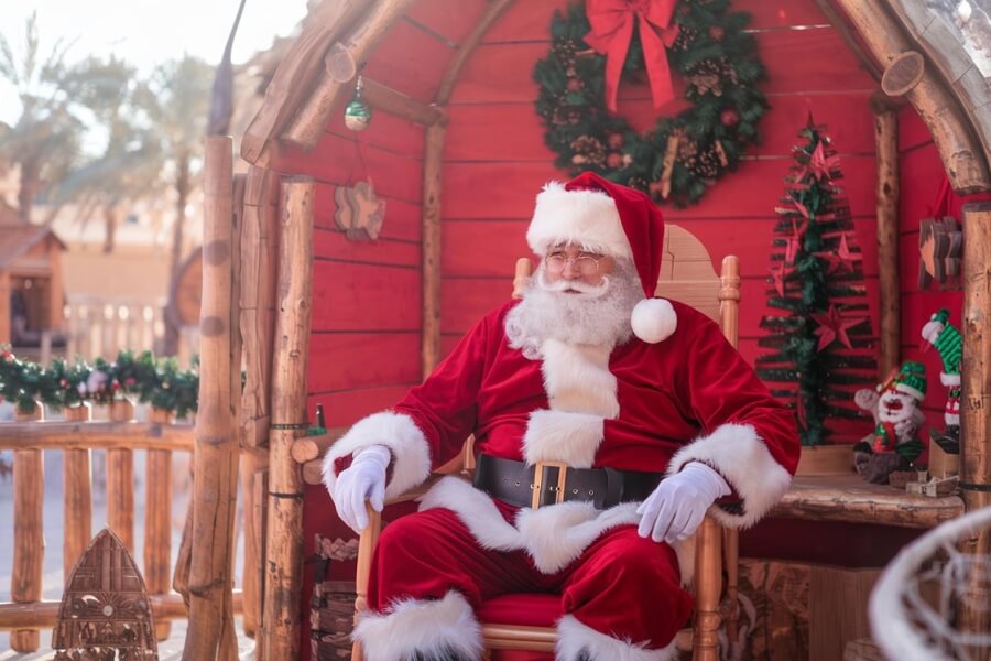 santa sitting in his grotto in a tropical setting in dubai