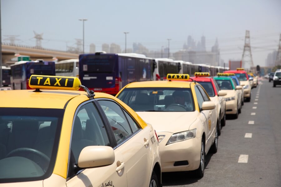 a row of taxis waiting for passengers in dubai