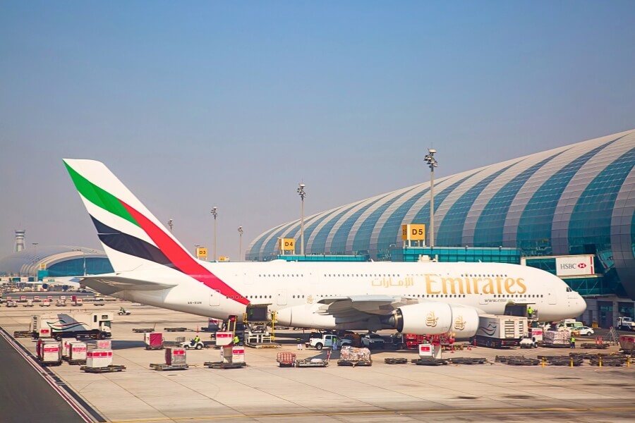 emirates A380 parked at DXB airport terminal